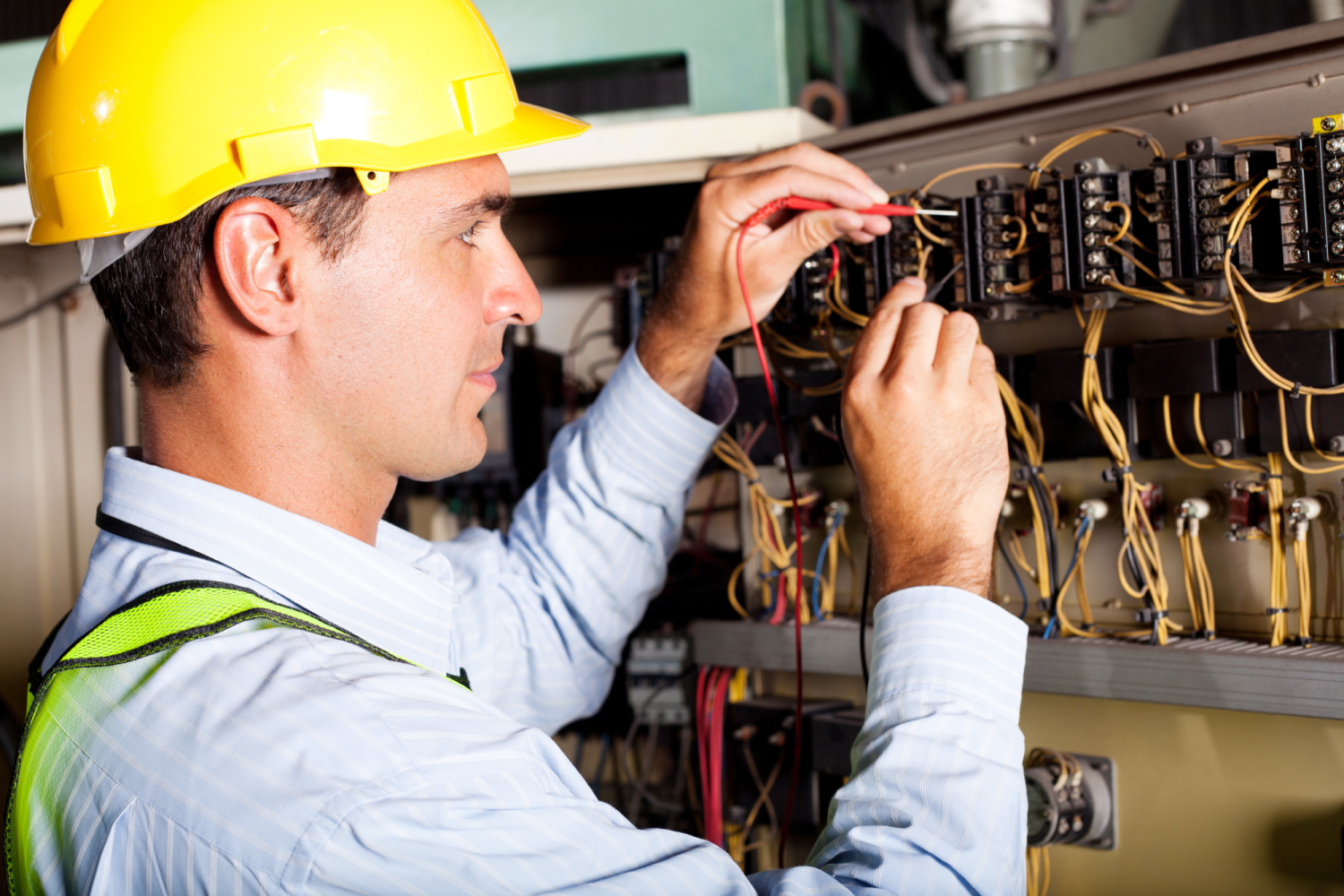 Residential Electrician checking wires in fuse box in Fuquay-Varina, NC